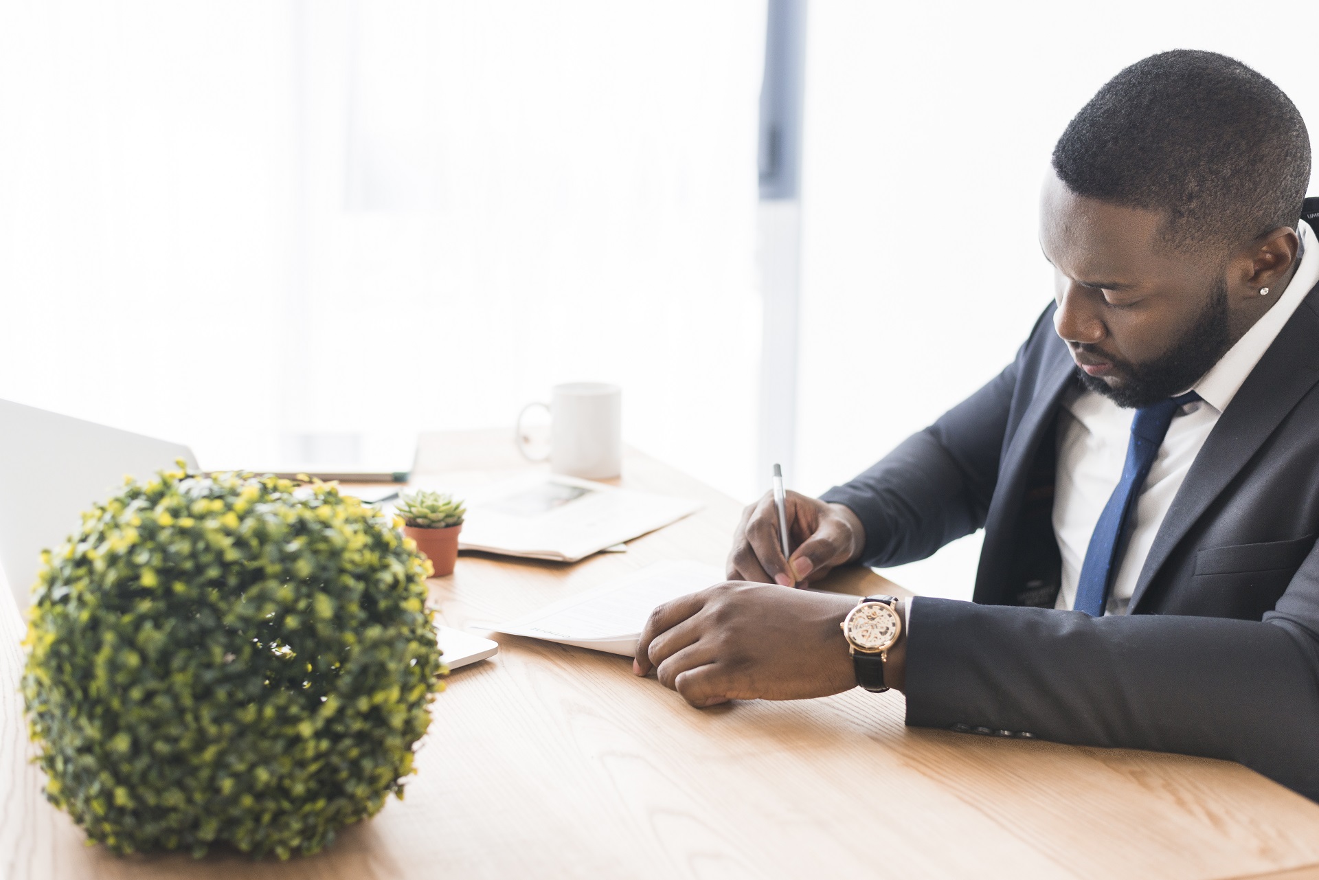 businessman-sitting-writing-table businessman-sitting-writing-table